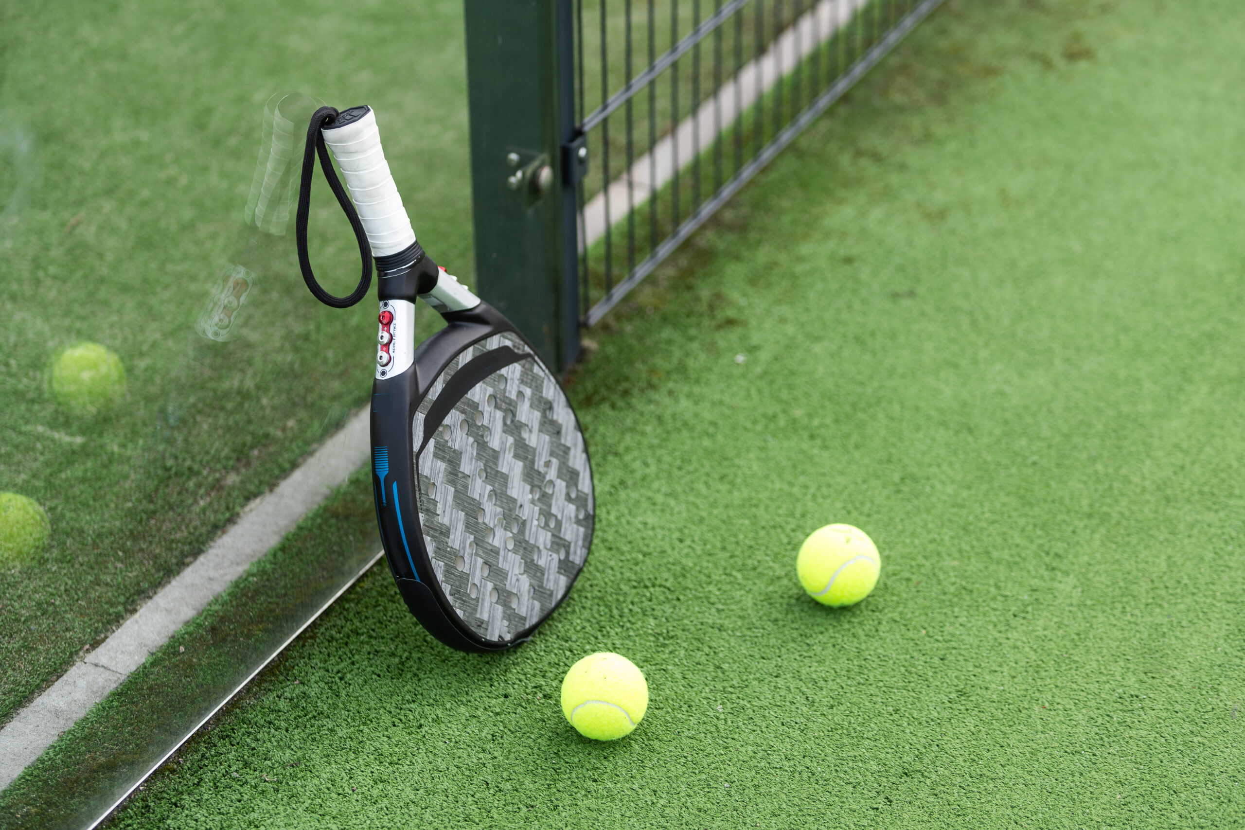 Padel Racket And Balls On The Court