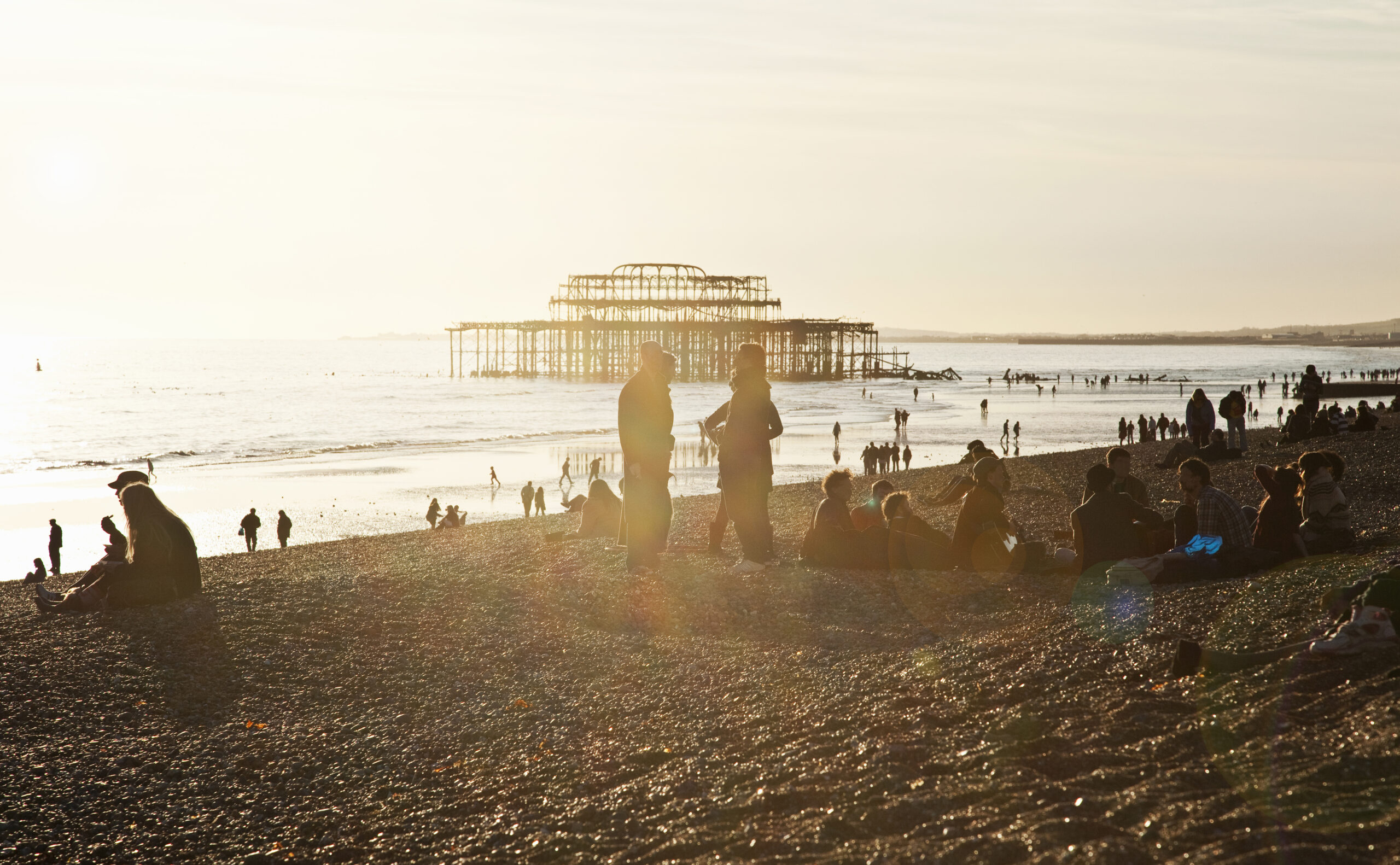 Brighton beach at sunset with the West Pier