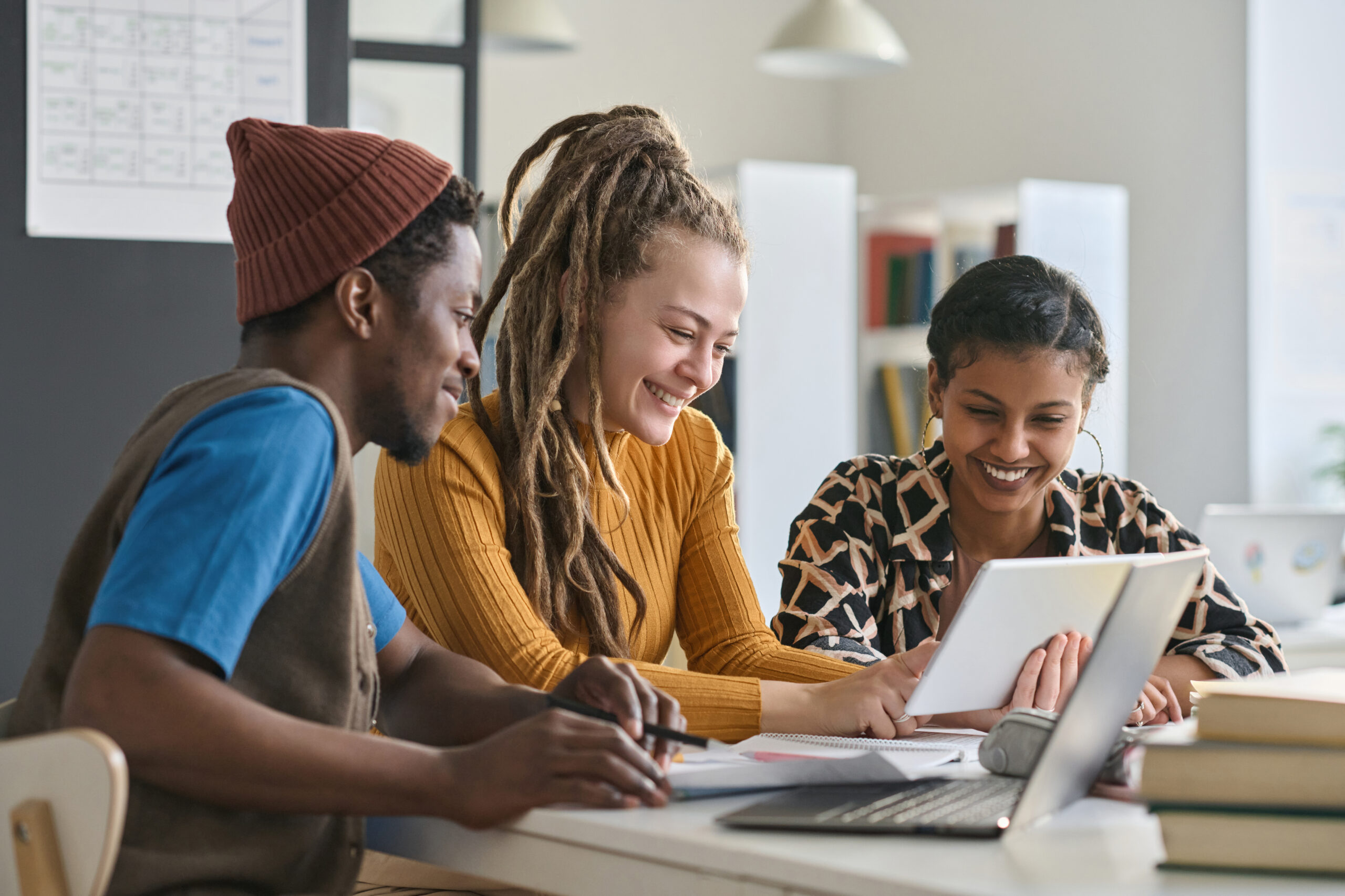 Smiling Young Adults Collaborating On A Project