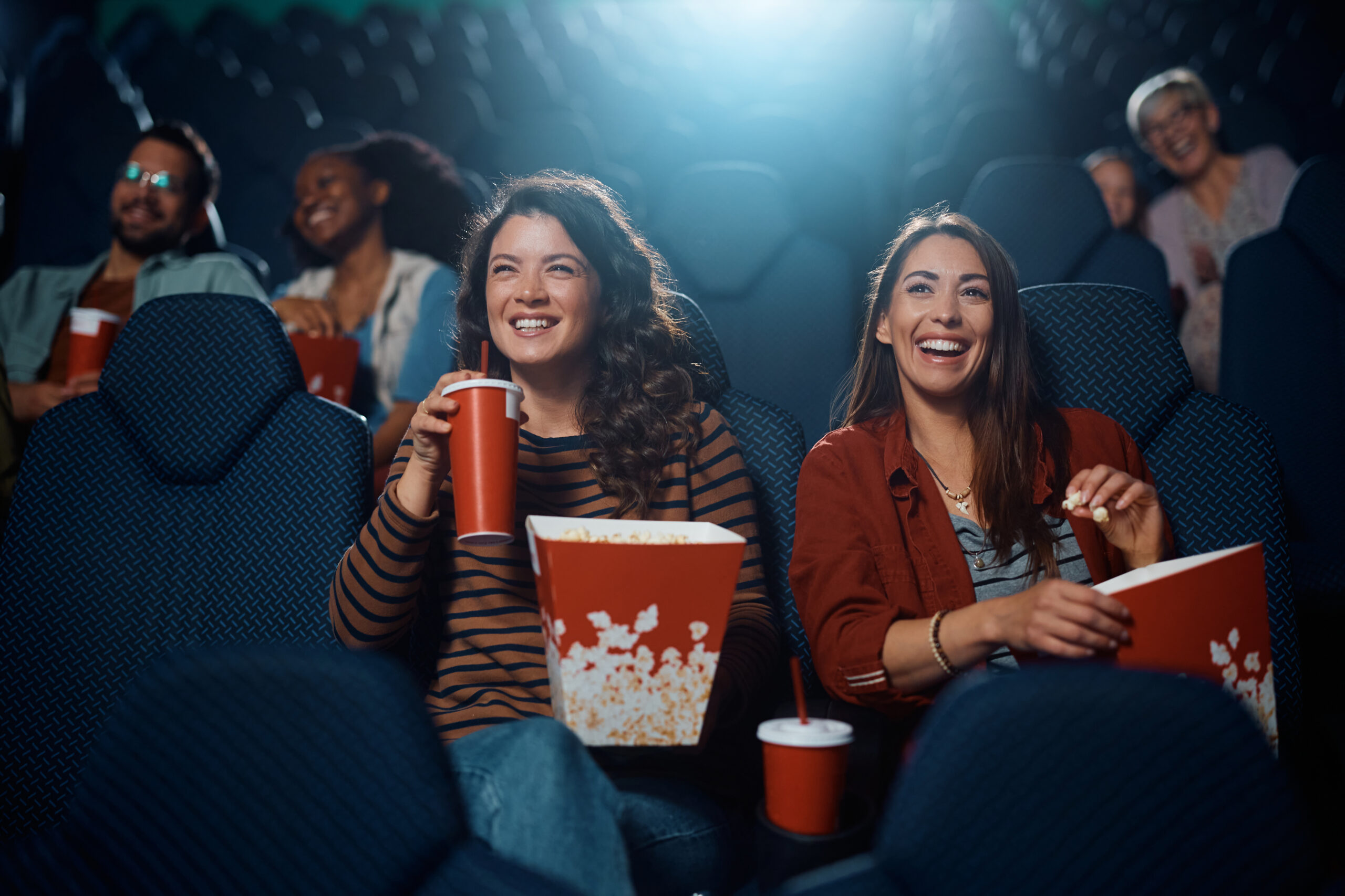 Young Happy Women Watching Movie In one of the Cinemas in Brighton
