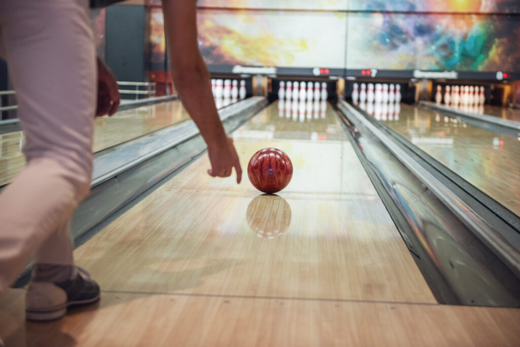 Bowling Ball On Wooden Lane With Pins