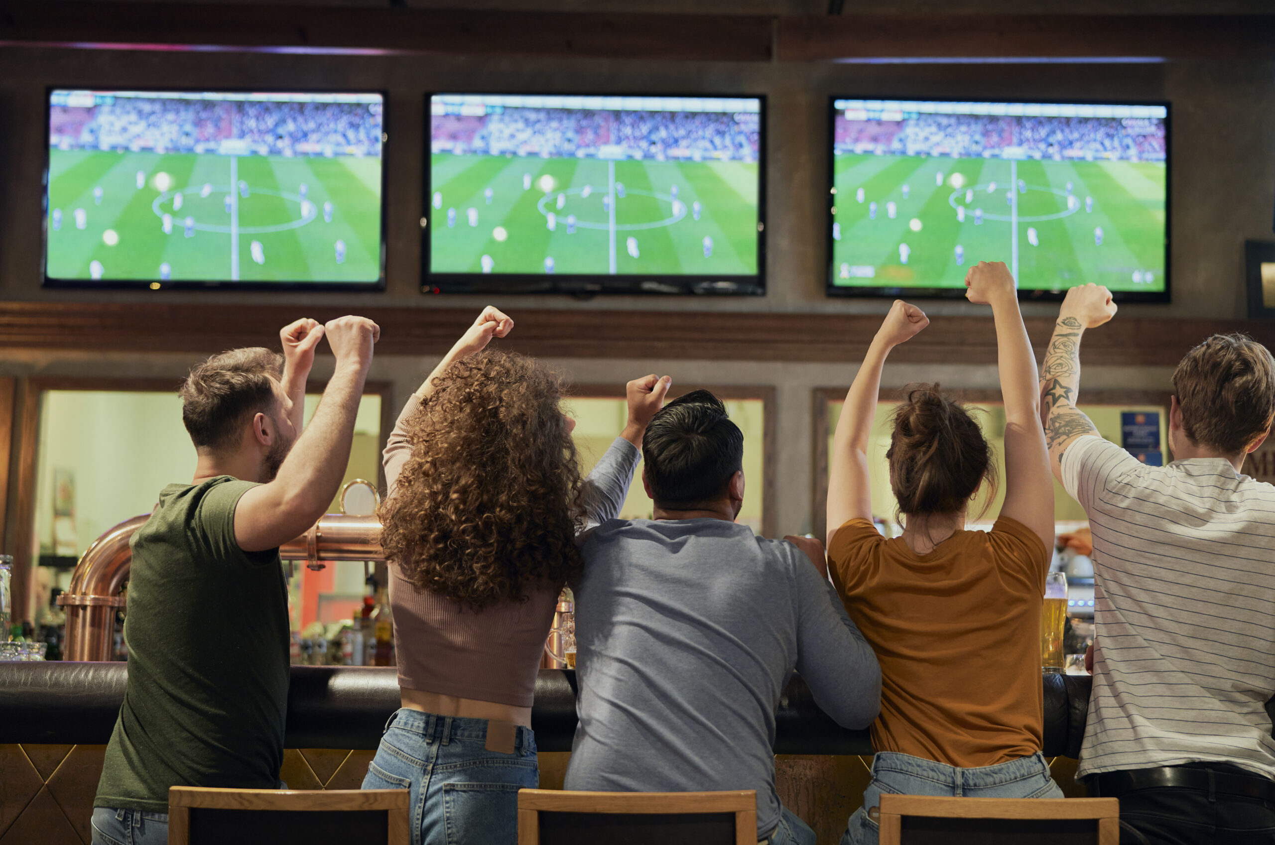 Cheering Friends Of Soccer Fans In The Pub trying to watch the World Cup in Brighton