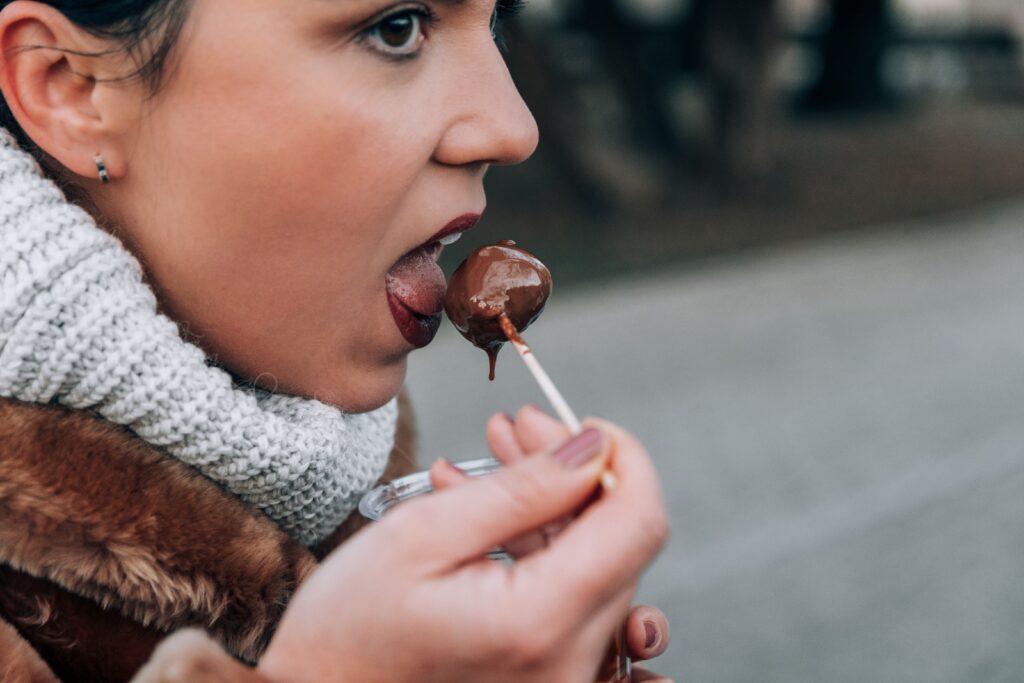 Close Up Photo Of Woman Eating chocolate at Brighton chocolate festival 