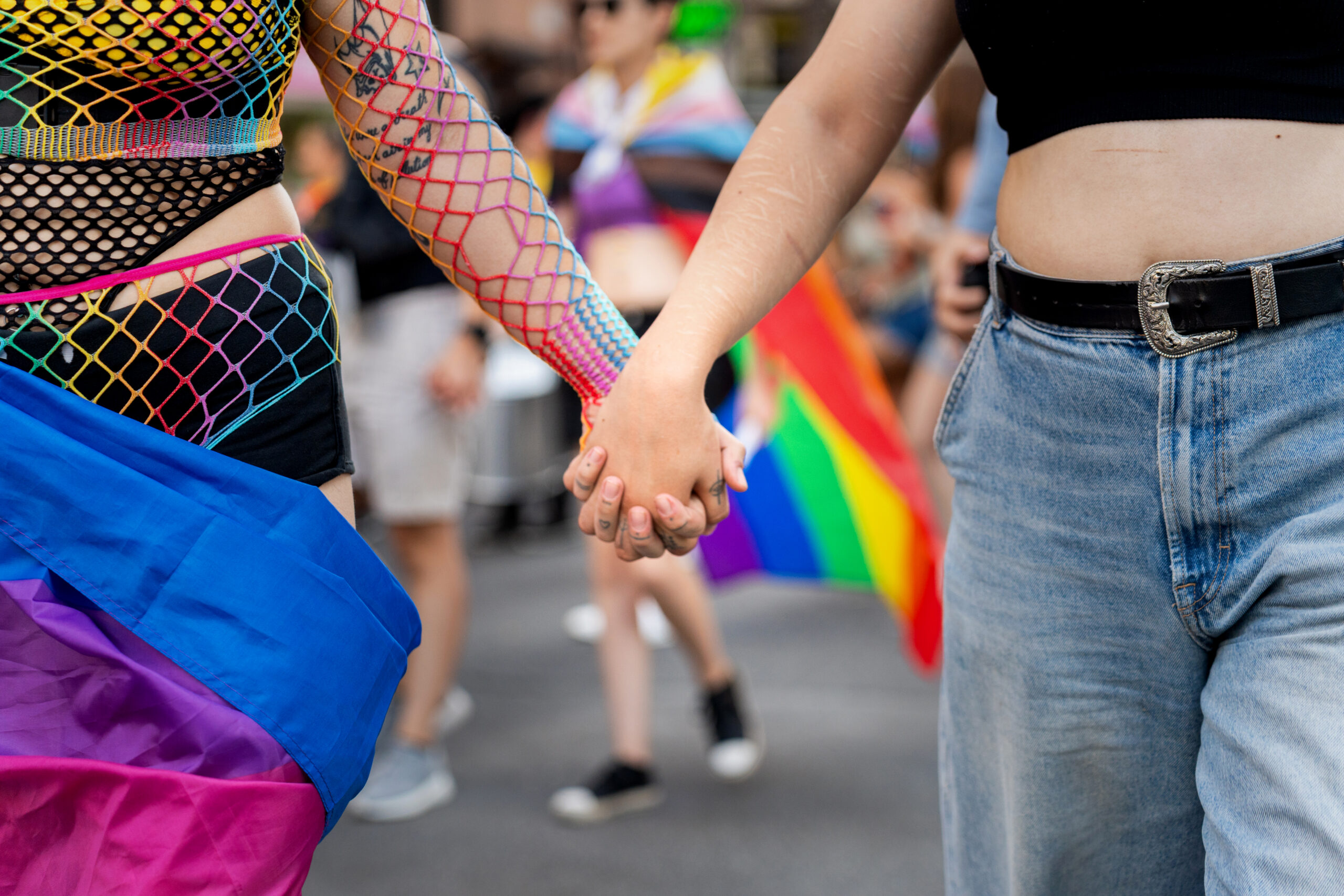 Couple Holding Hands At Colourful Pride Parade