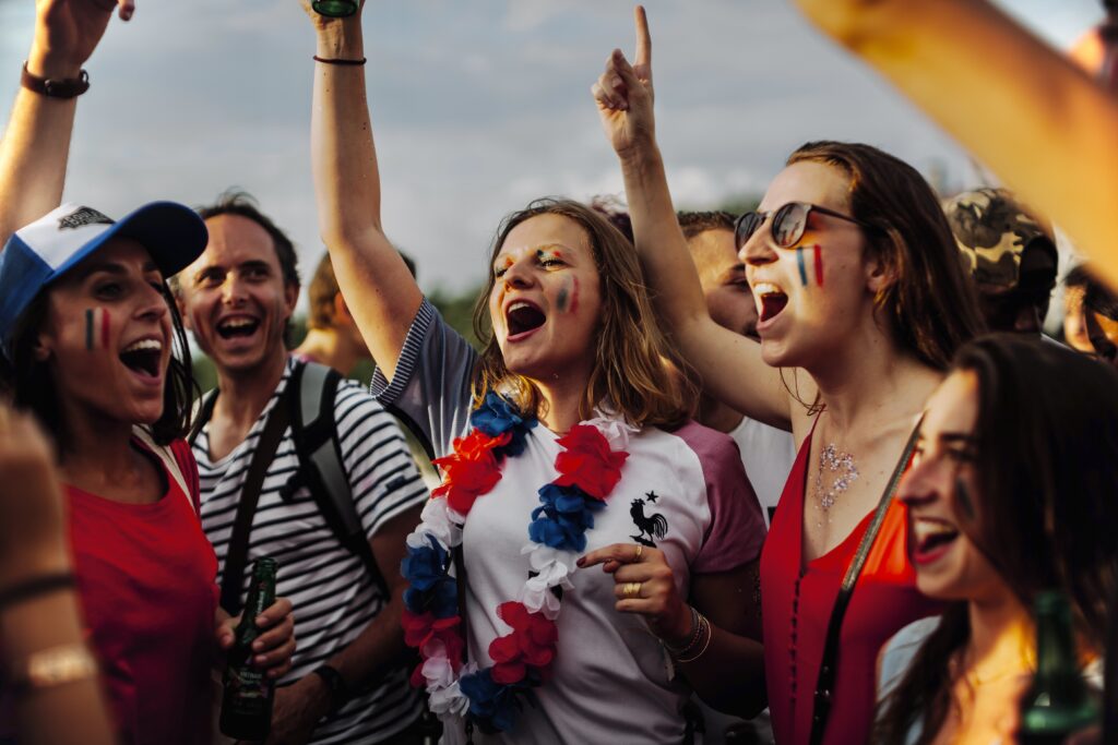 Excited Crowd Celebrating Victory With Painted Faces