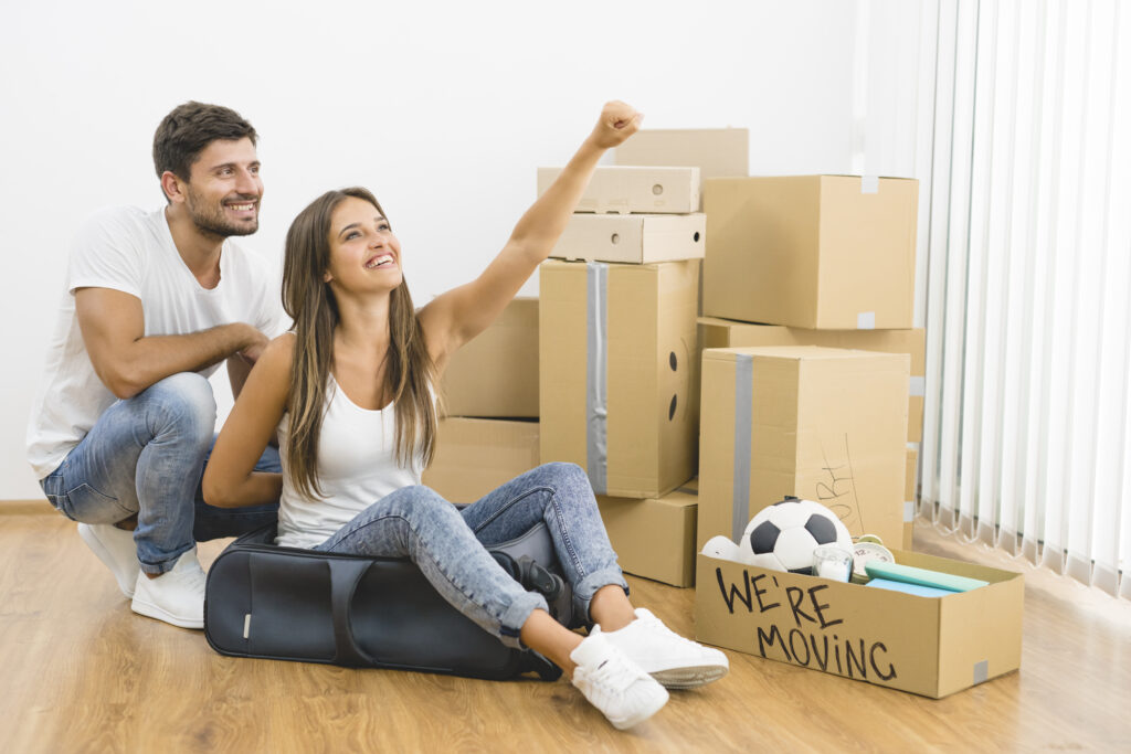 Excited Young Couple Moving Into A New Home