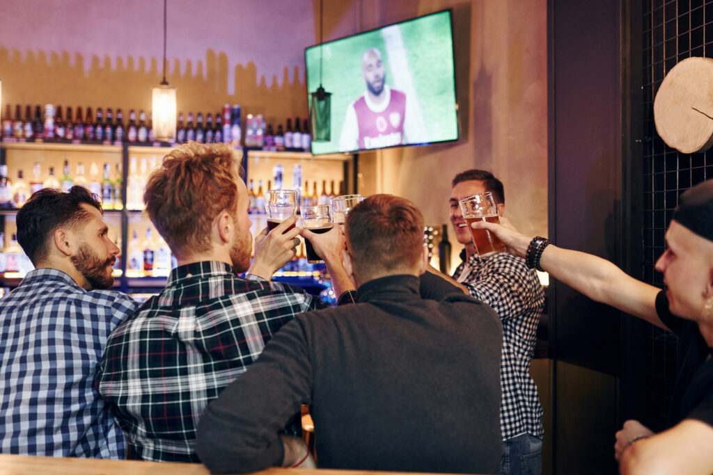 Group of people together indoors in the pub have fun at weekend time.