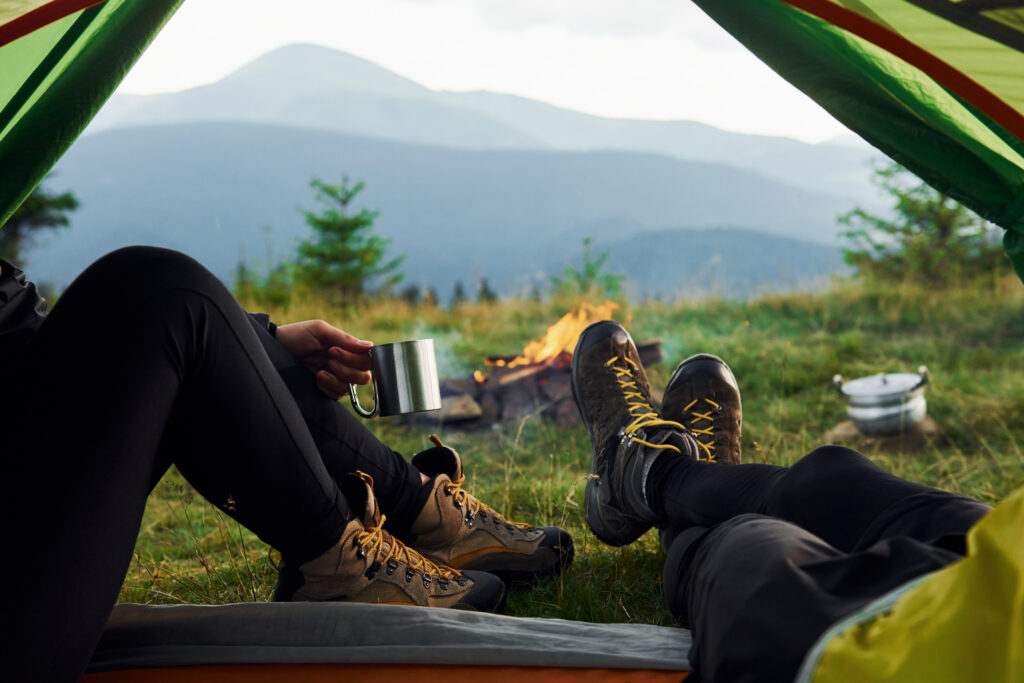 Man and woman inside of tent together.