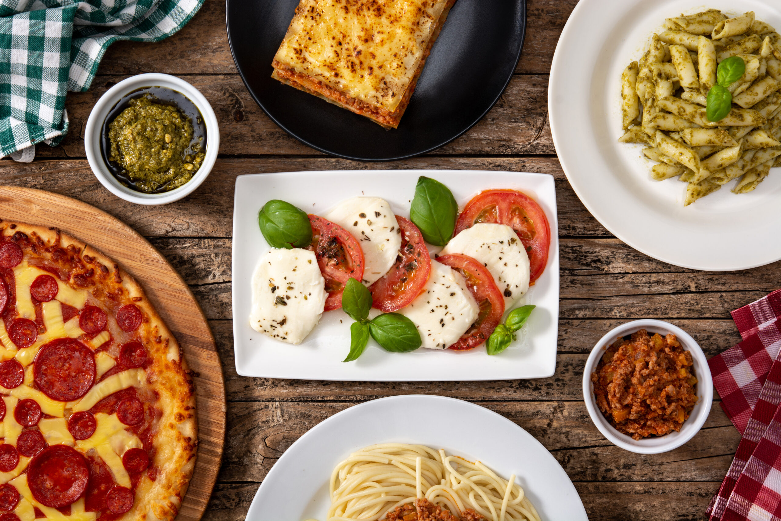 Various Italian Food Dishes On A Wooden Table