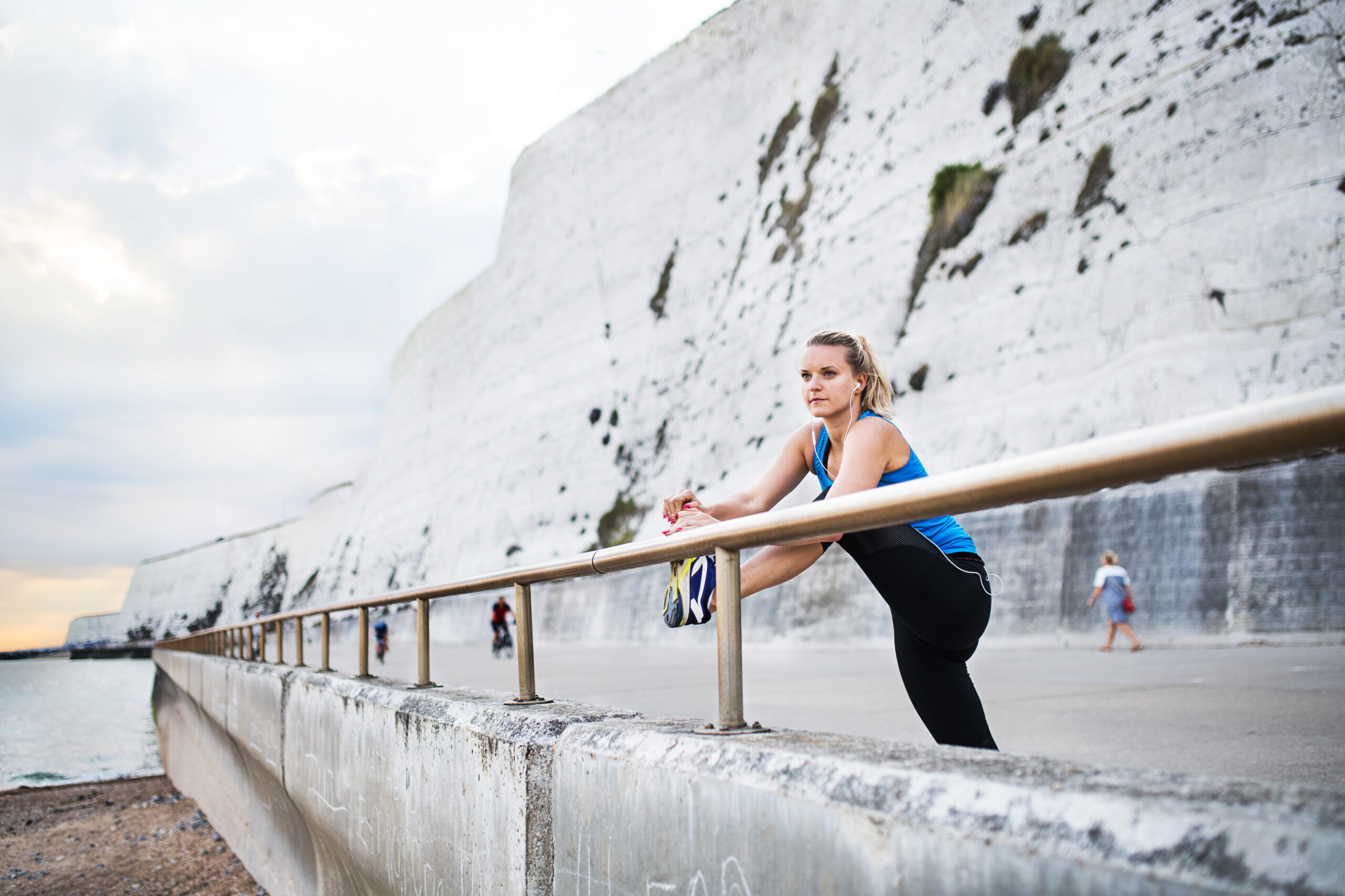 Young woman stretching on Rottingdean beach
