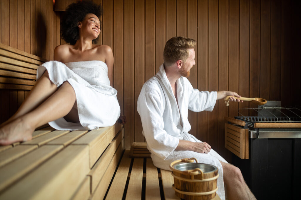 People enjoying sauna health benefits in spa hotel
