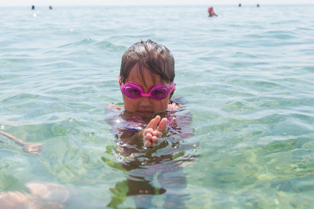 Summer Holiday Happy Portrait Of Little Girl In The Sea