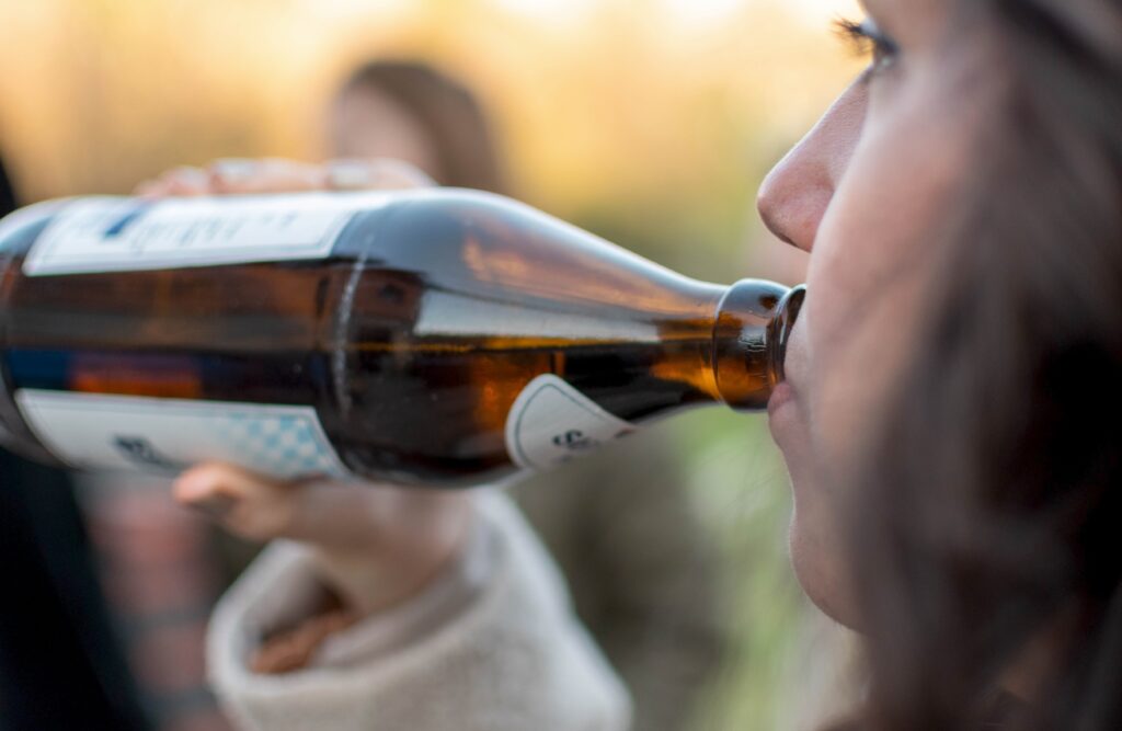 Close Up Image Of Woman Drinking Beer From Bottle