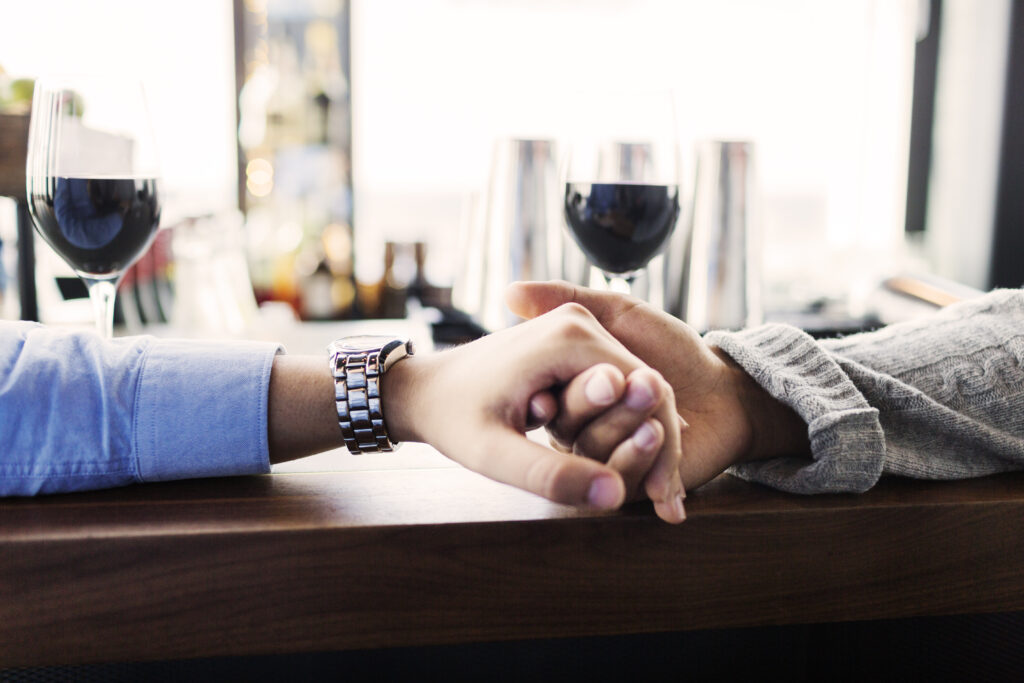 Couple holding hands in a restaurant