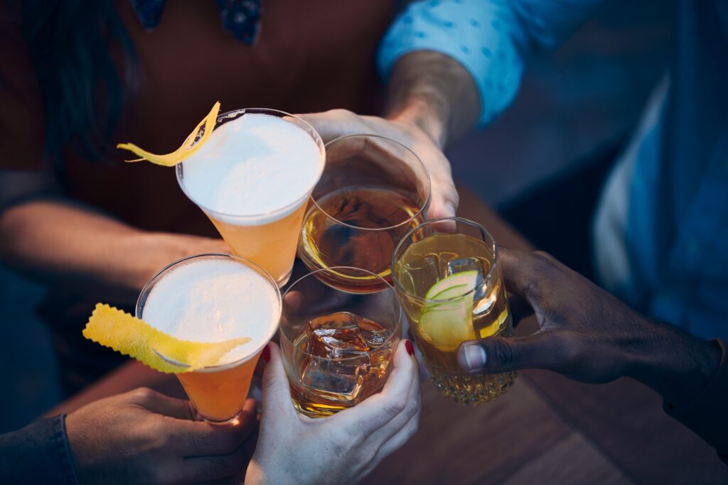 Alcohol Free Brighton: A closeup shot of many people clinking glasses with alcohol at a toast