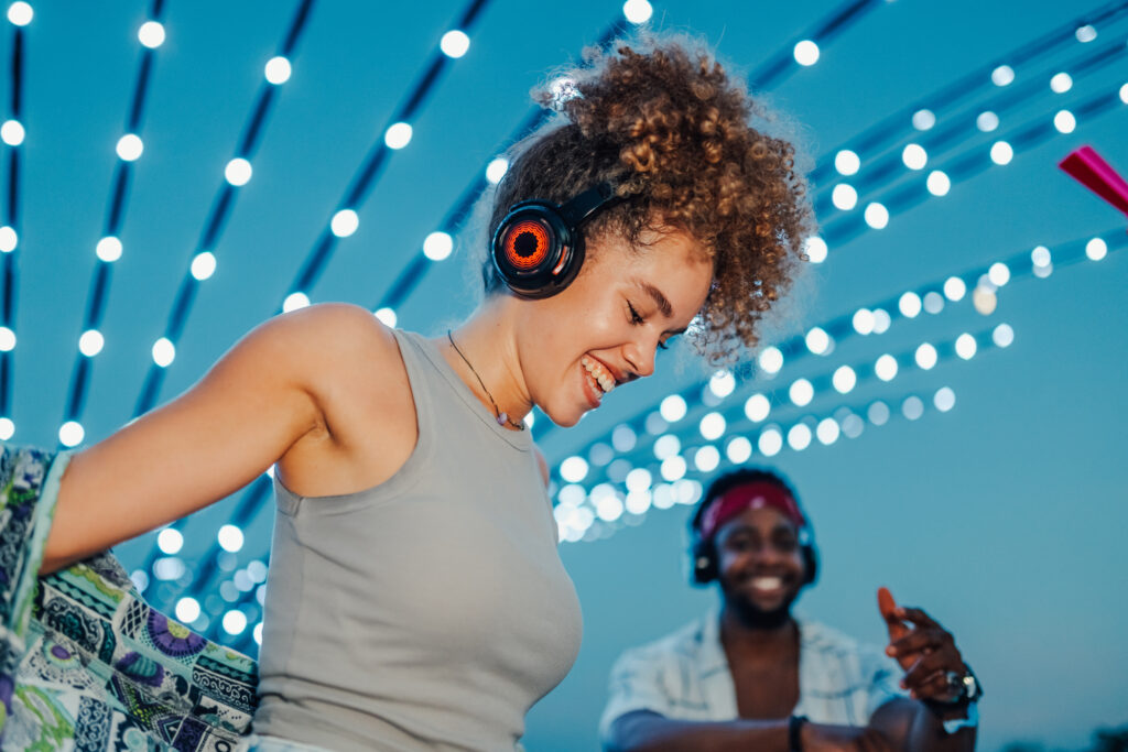 Smiling Young Woman Wearing Headphones At Night