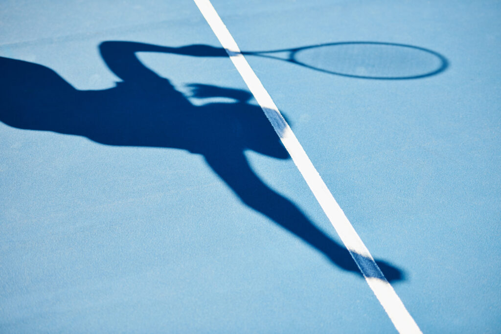 Tennis Player Shadow On Blue Court 