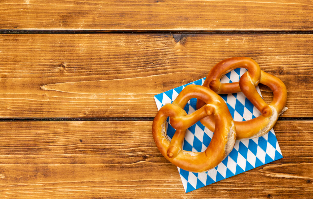 A closeup shot of pretzel for Oktoberfest on a brown table