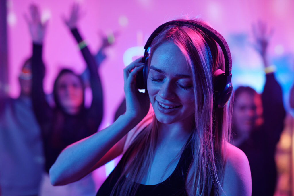 Woman Enjoying Music With Headphones In A Club